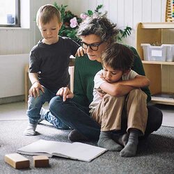 Förskolepedagog läser högt för tre barn | © Maskot / Getty Images