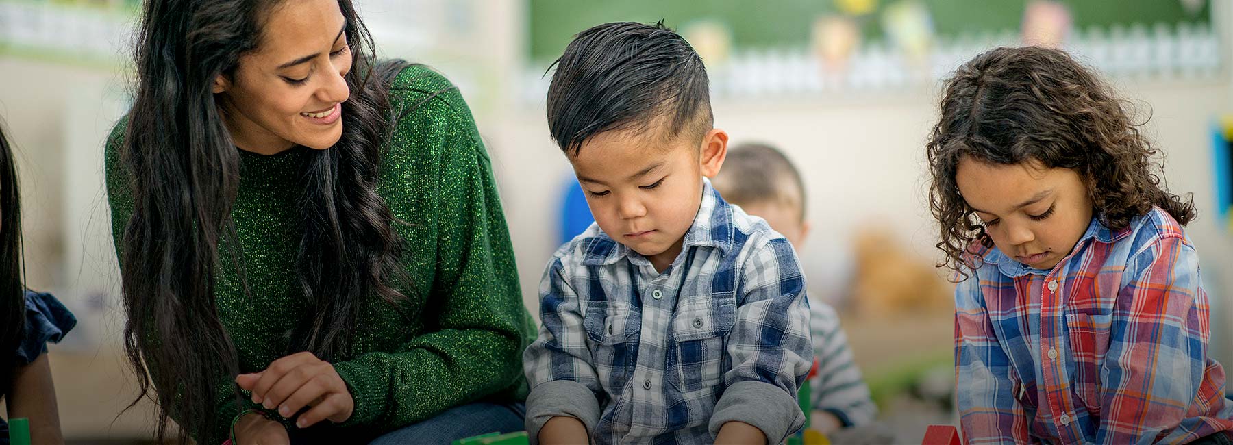 Glad pedagog med två barn - Processutbildningar för förskolan | © Getty Images